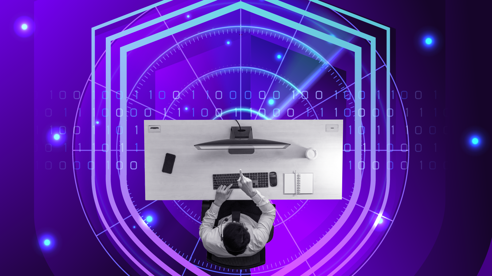 Man at computer surrounded by a shield hologram